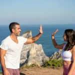 happy couple shaking hand at beach